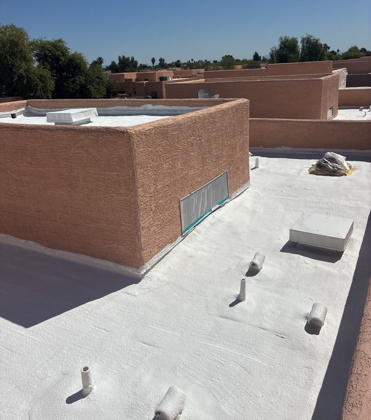 After photo of the rebuilt Peoria foam roof with new one-inch foam, white elastomeric coating, and newly foamed penetrations