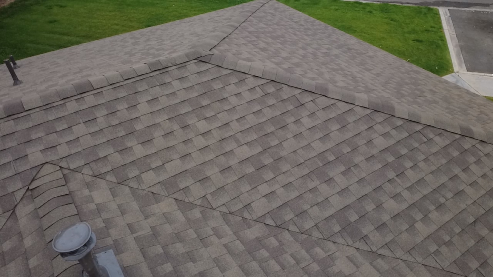 CS14 7 After photo of the finished shingle roof with crisp new hip and ridge lines and GAF ridge cap running along the ridge