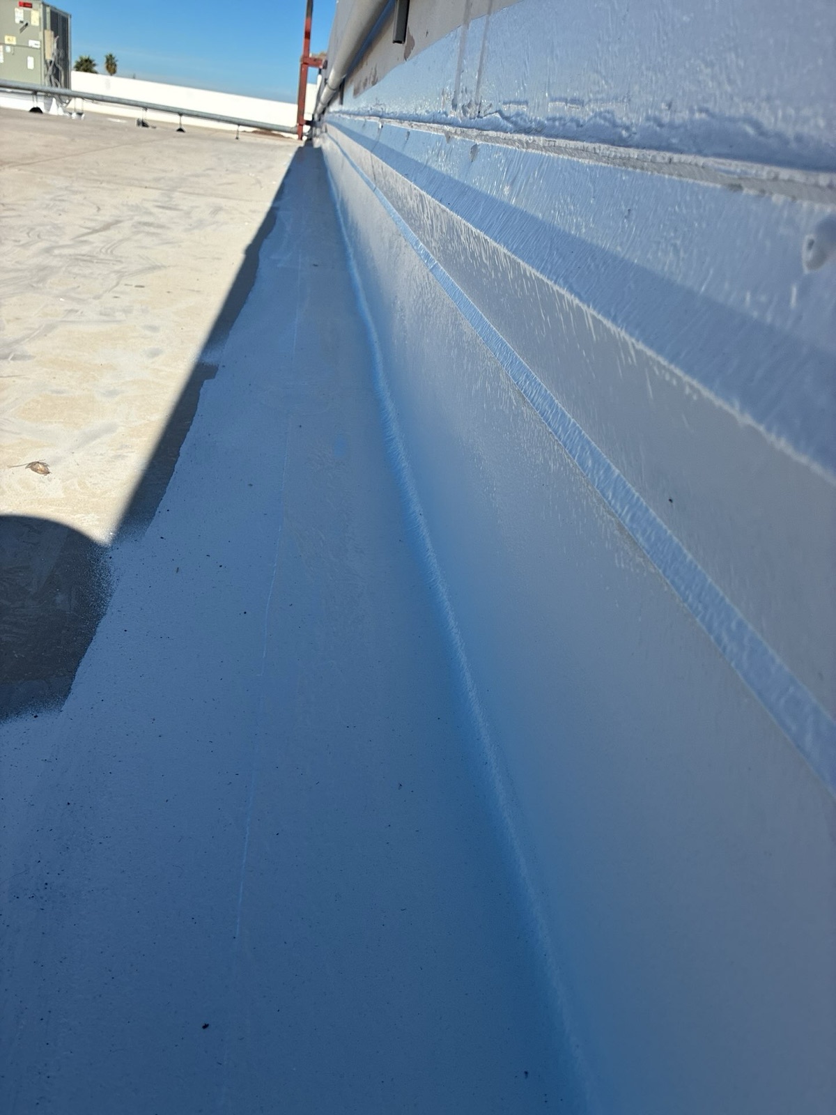 CS15 7 After photo of fresh silicone coating carried up the wall and across the membrane at the base, sealing the transition detail