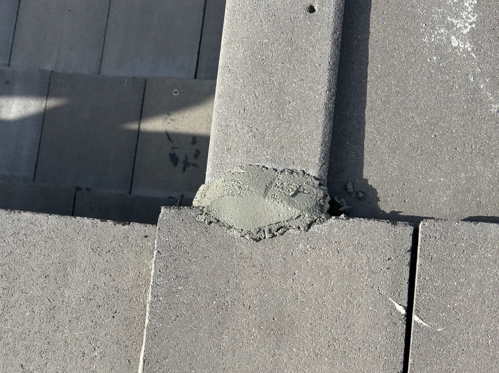 CS16 2 After photo of a freshly re-mortared cap on the Tempe tile roof with the original tiles re-set around it