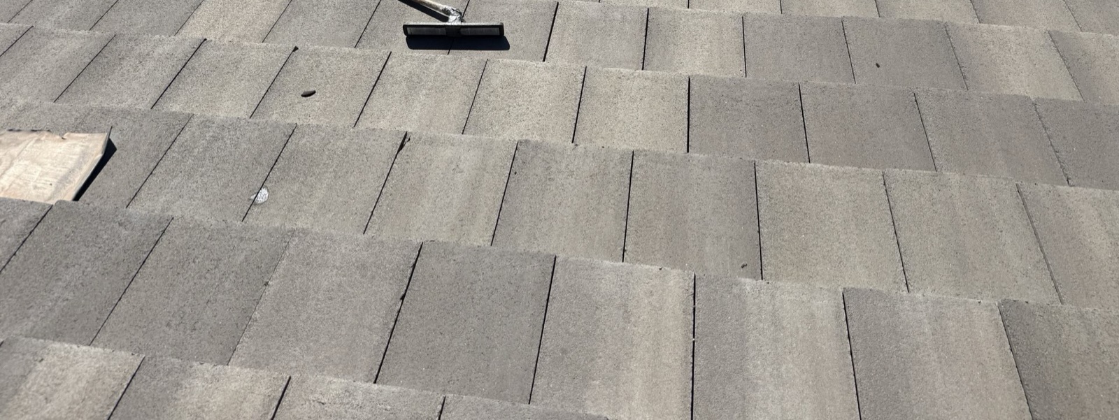 CS16 5 After photo of a swept Tempe tile roof with the original concrete tiles re-installed in even courses and a push broom left mid-cleanup