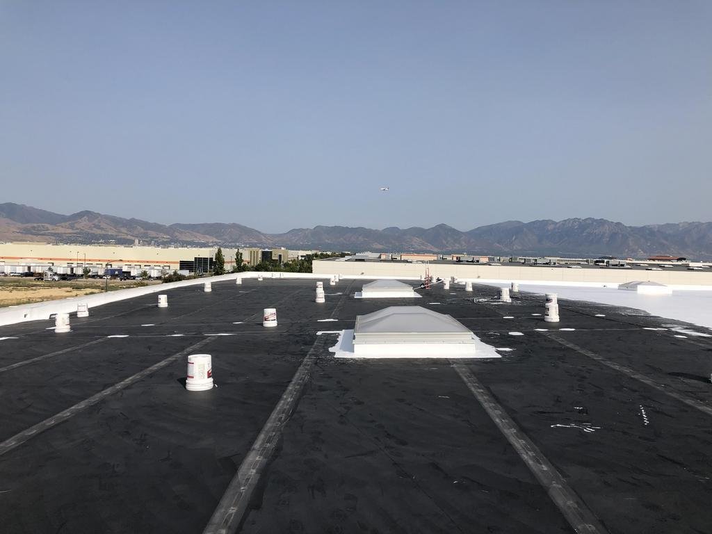 CS6 1 Before photo of an aging EPDM membrane roof on a Salt Lake City commercial office building, with seams and penetrations being prepped for coating