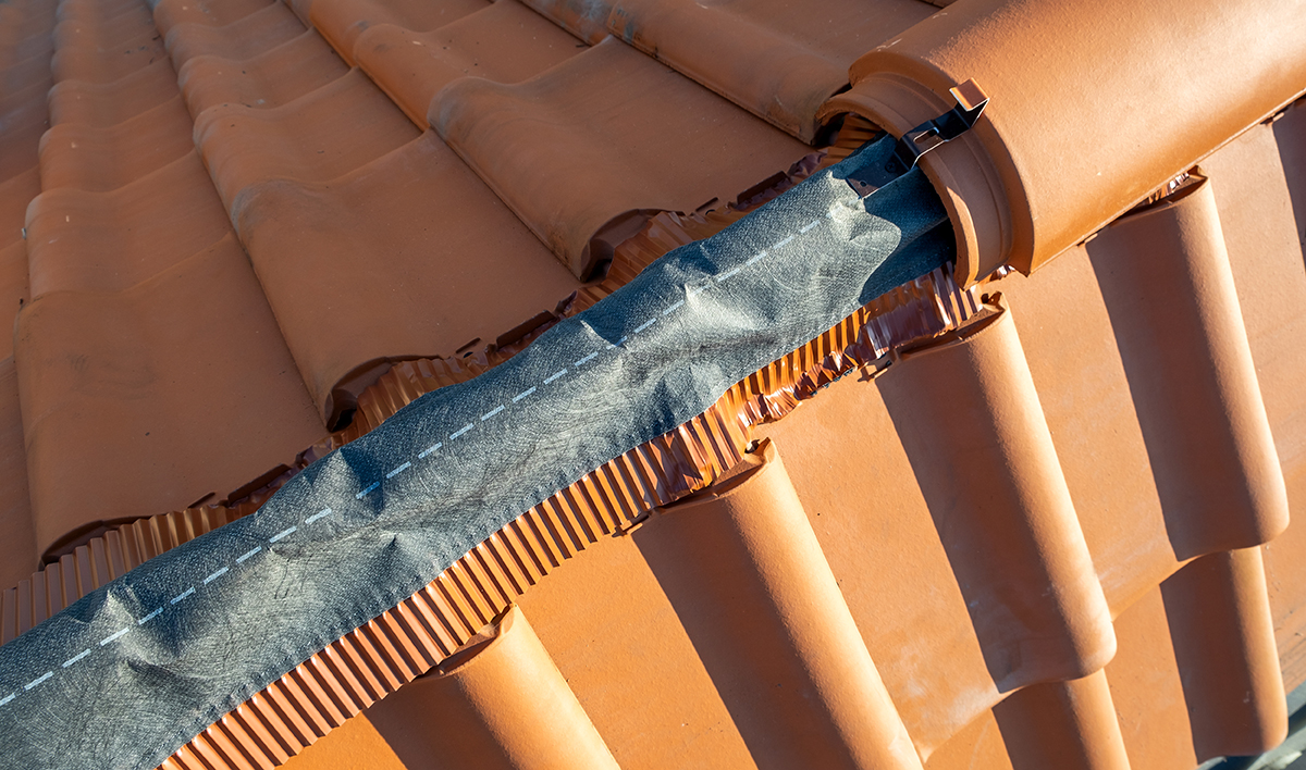 Closeup Of Yellow Ceramic Roofing Ridge Tiles On Top Of Resident