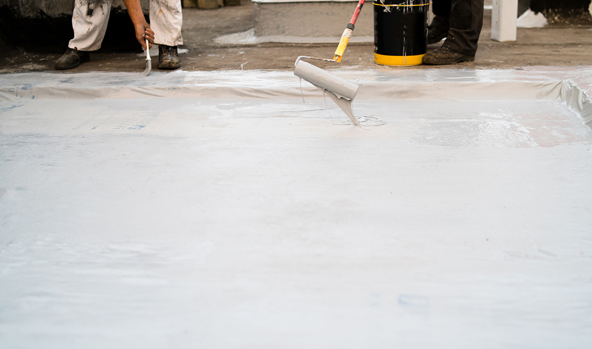 Roof Insulation, Two Man Applying Material Using The Paint Rolle