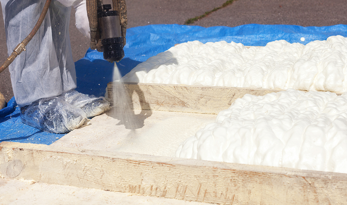 Technician Spraying Foam Insulation Using Plural Component Spray Gun Spraying Polyurethane Foam For Roof