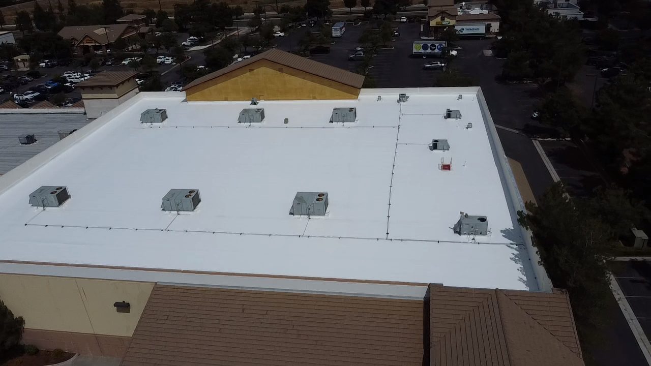 Aerial after photo of the restored white silicone roof coating on the Temecula retail building