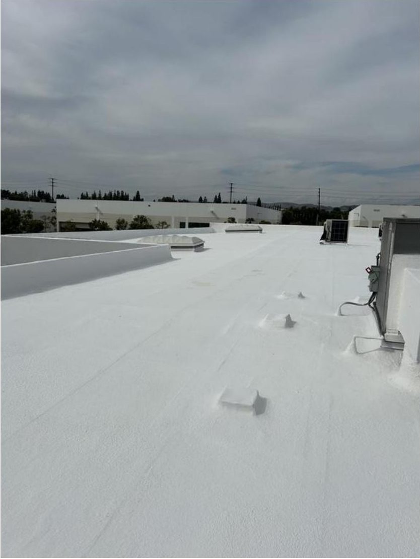 After photo showing the freshly applied white elastomeric coating on the Anaheim warehouse roof