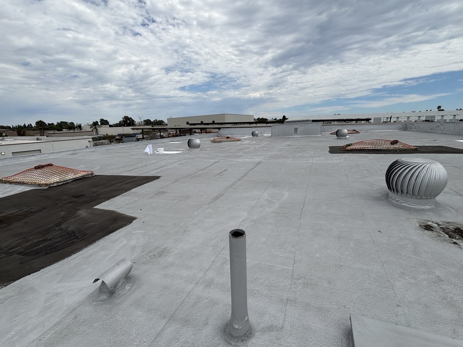 Before photo of an aging foam roof on a Long Beach warehouse with active leaks prior to recoating
