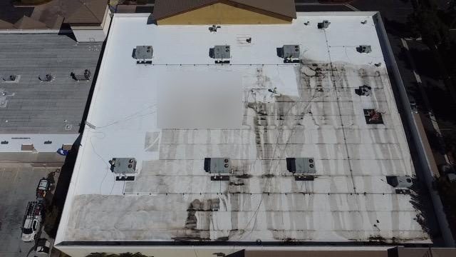 Aerial before photo of an existing TPO roof on a former big-box retail building in Temecula prior to restoration
