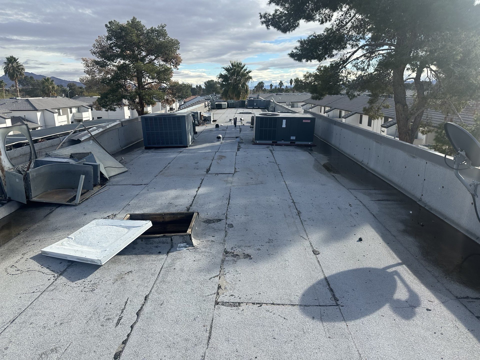 Before photo of a deteriorated cap sheet roof in a Las Vegas apartment community with active leaks