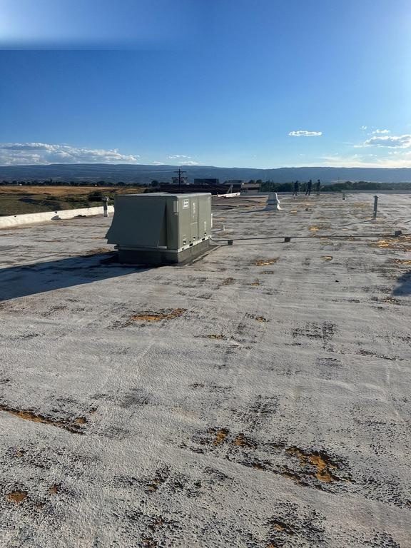 CS7 1 Before photo of an aging polyurethane foam roof on a Grand Junction commercial building, showing a worn and weathered surface