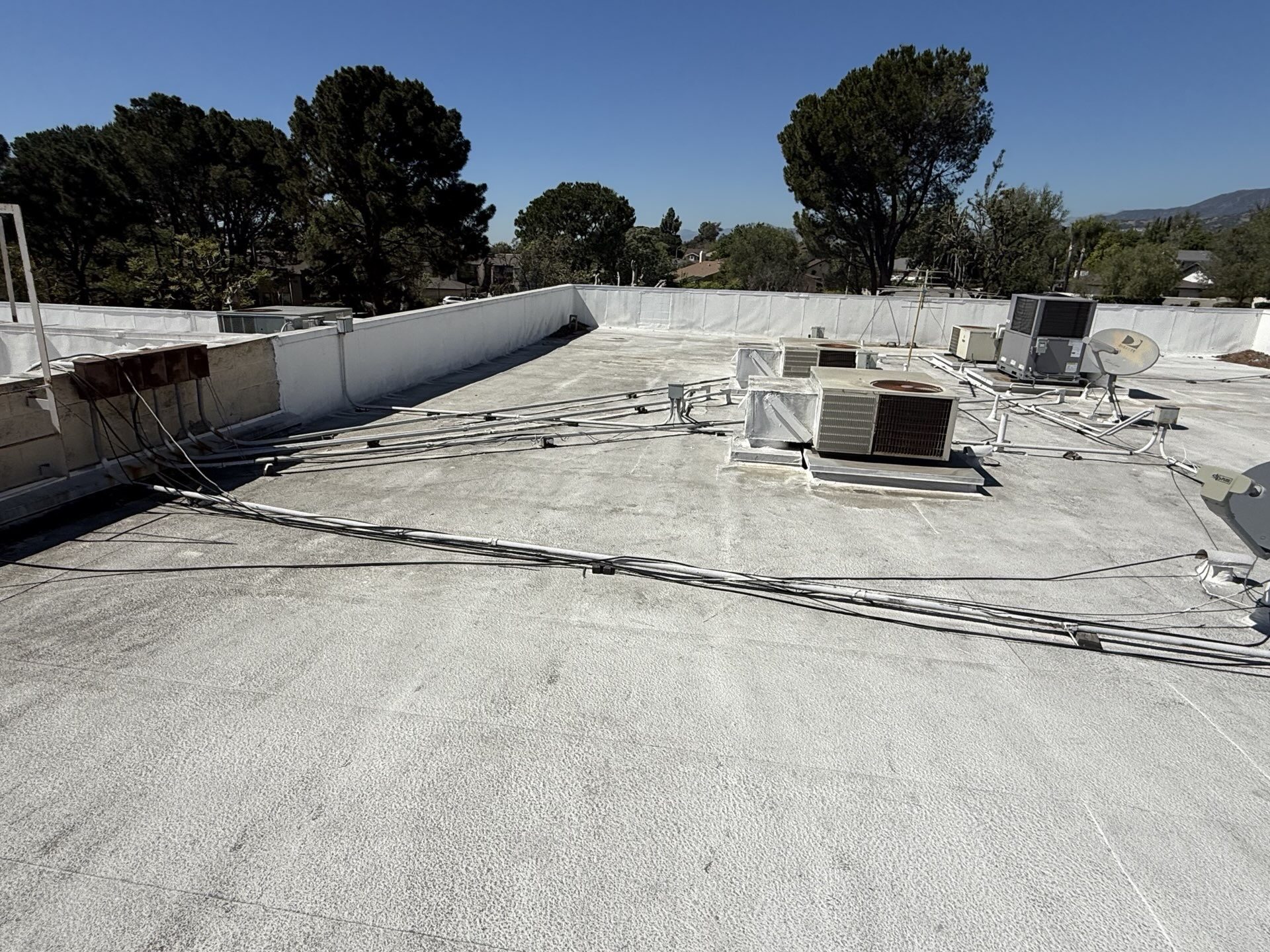 Before photo of an aging built-up roof on a Claremont commercial building prior to recoating