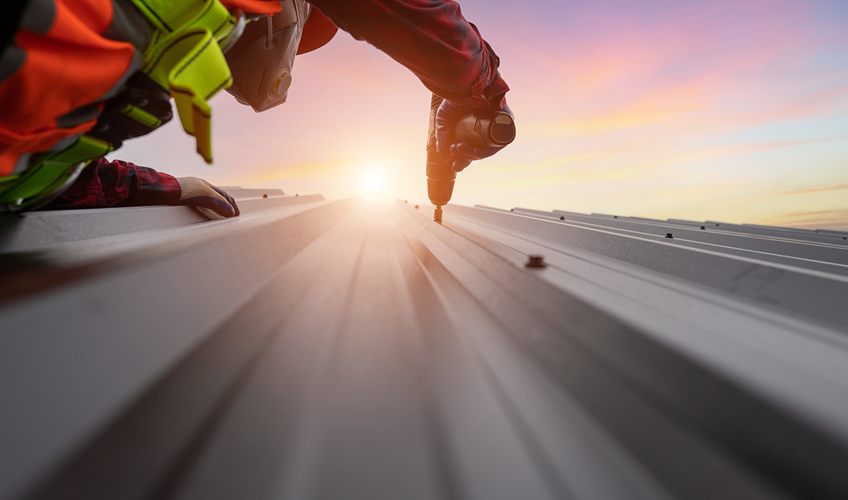 Close Up Shot Roofing Worker Installing Metal Sheet Roof On The