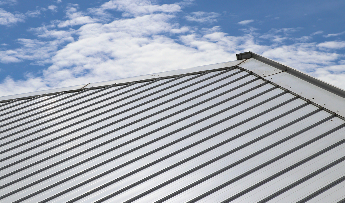 Metal Sheet Roof And Slope With Clouds And Blue Sky Background
