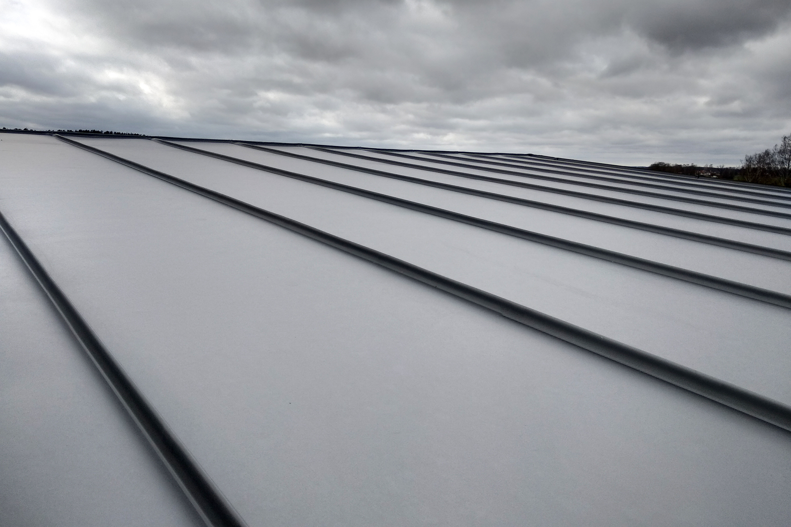Close Up Detail Of House Roof Made From Gray Metal Sheets