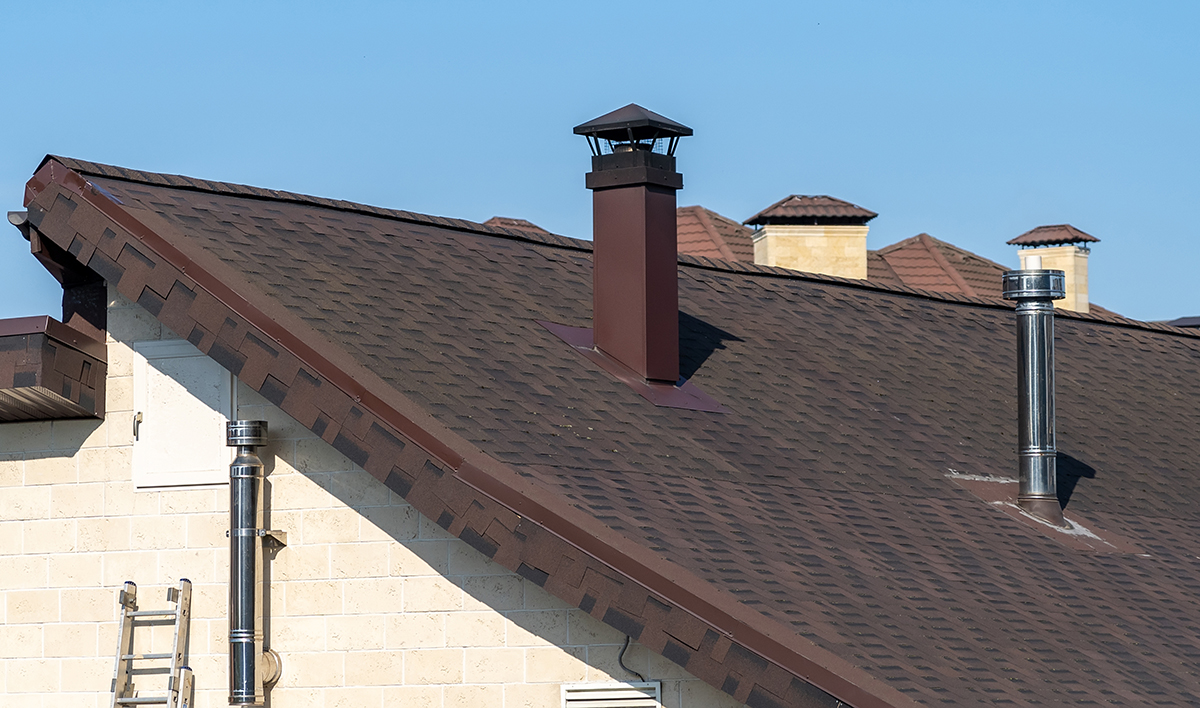 Brown Roof Of House Covered With Motleysoft Shingles With Smokes