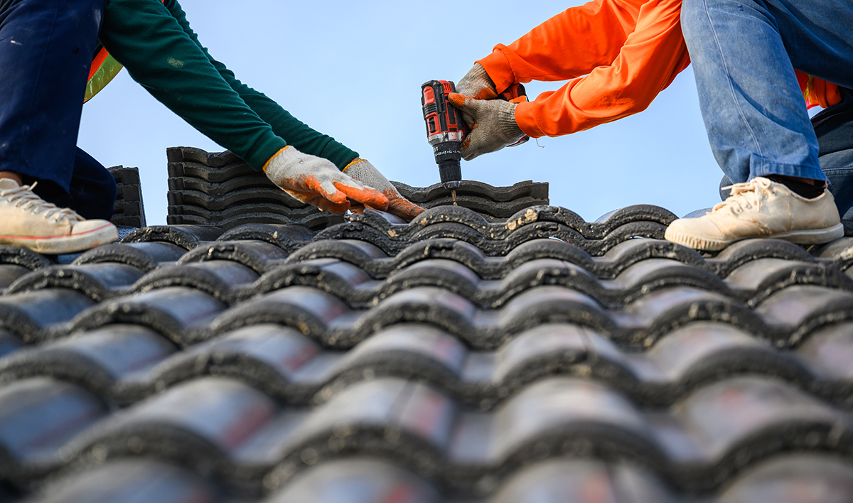 Close Up Photo Of A Roofer Working On The Roof Of The House Use